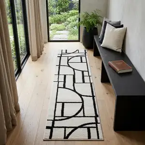 Photo of 7' Ivory And Black Geometric Runner Rug