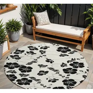 Photo of 8' Ivory And Black Round Floral Washable Indoor Outdoor Area Rug