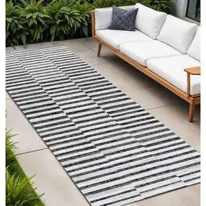 Photo of 10' Ivory And Black Striped Indoor Outdoor Runner Rug