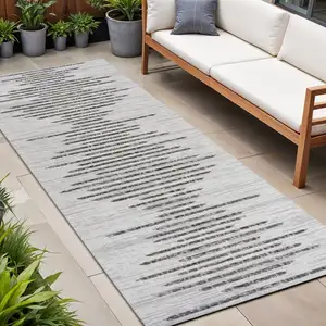 Photo of 10' Ivory And Black Striped Indoor Outdoor Runner Rug