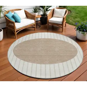 Photo of 8' Ivory And Brown Round Striped Washable Indoor Outdoor Area Rug