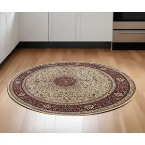 Photo of 6' Ivory And Red Oriental Round Rug