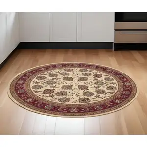 Photo of 6' Ivory And Red Oriental Round Rug