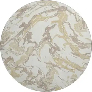 Photo of 8' Ivory Beige And Gold Abstract Washable Round Rug With UV Protection