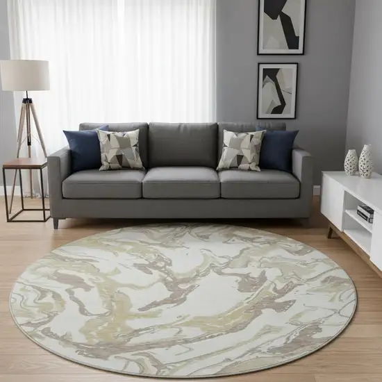 8' Ivory Beige And Gold Abstract Washable Round Rug With UV Protection Photo 2
