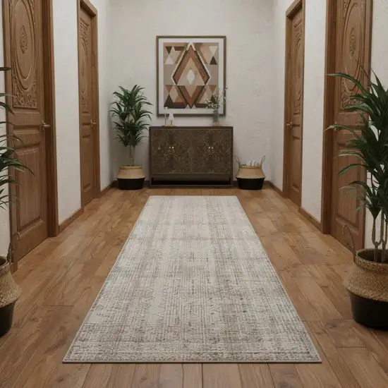 10' Ivory Brown And Gray Geometric Distressed Runner Rug With Fringe Photo 1