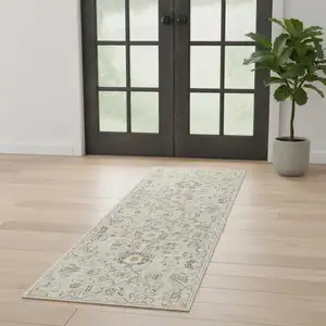 Photo of 6' Ivory Floral Worn Faded Runner Rug