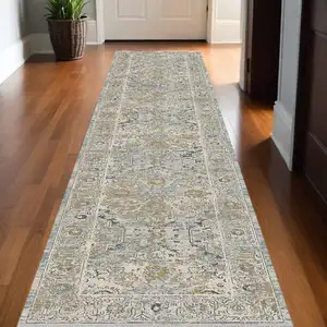 Photo of 12' Ivory Tan And Light Blue Floral Medallion Distressed Runner Rug With Fringe