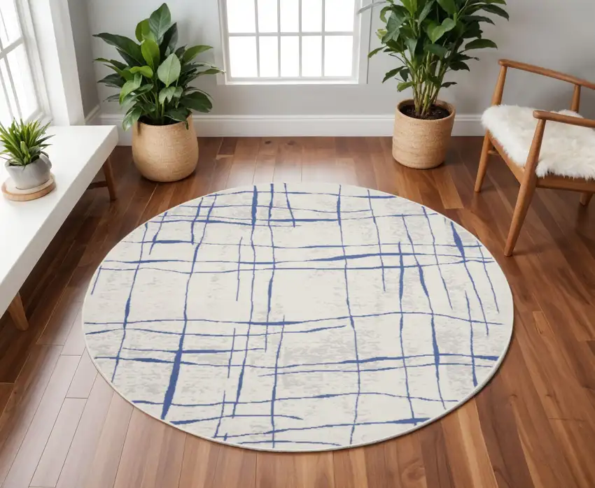 8' Ivory and Blue Abstract Distressed Round Rug Photo 1