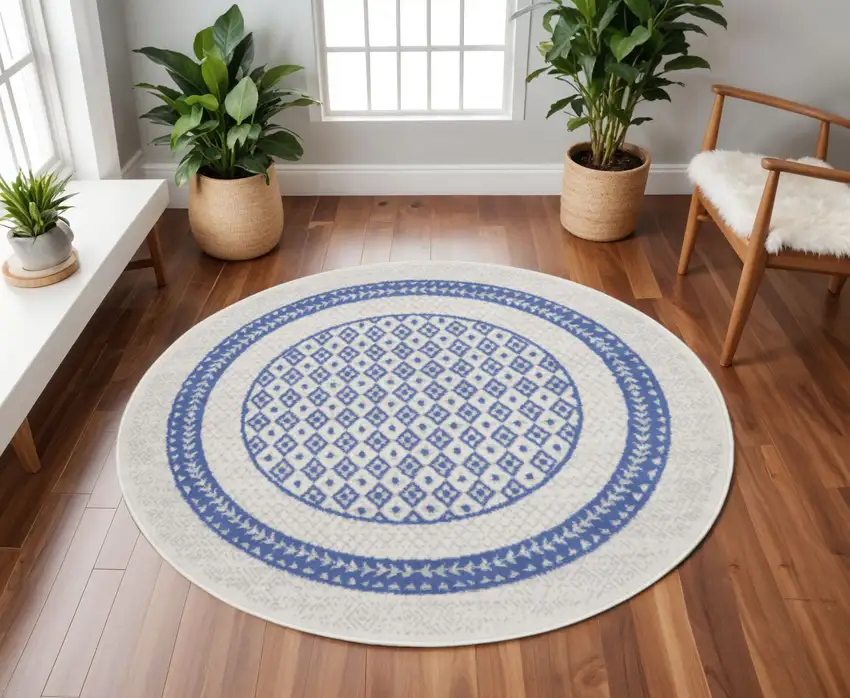 8' Ivory and Blue Geometric Distressed Round Rug Photo 1