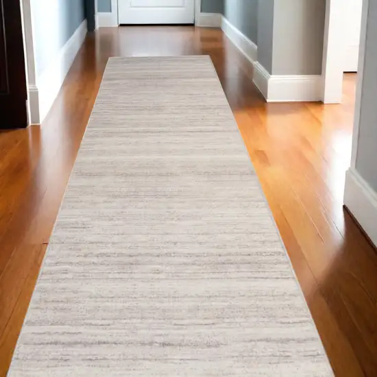 10' Ivory and Light Brown Abstract Washable Runner Rug Photo 1