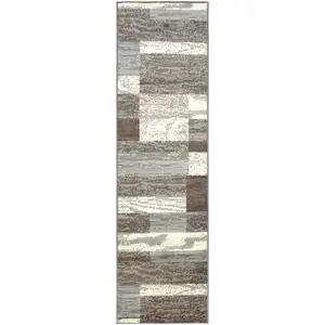 Photo of 10' Light Blue And Ivory Patchwork Power Loom Stain Resistant Runner Rug
