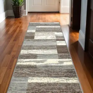 Photo of 10' Light Blue And Ivory Patchwork Power Loom Stain Resistant Runner Rug