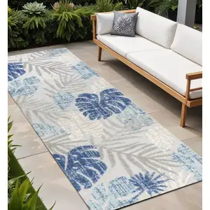 Photo of 8' Light Gray And Navy Blue Floral Indoor Outdoor Runner Rug
