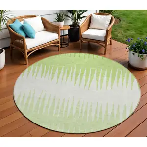 Photo of 8' Lime Green And Ivory Round Striped Washable Indoor Outdoor Area Rug
