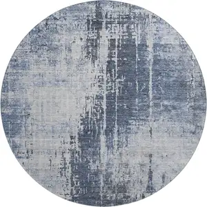 Photo of 8' Navy Blue And Ivory Abstract Washable Round Rug With UV Protection