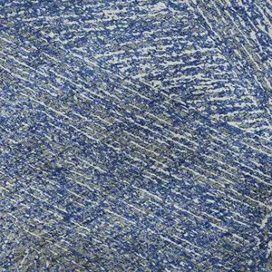 Photo of 8' Navy Blue And Ivory Abstract Washable Round Rug With UV Protection