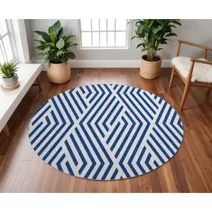 Photo of 8' Navy Blue And Ivory Geometric Washable Round Rug With UV Protection