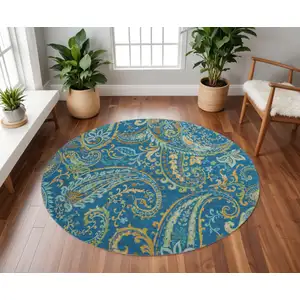 Photo of 8' Navy Blue Green And Gold Paisley Washable Round Rug With UV Protection