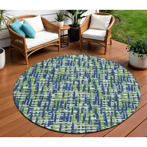 Photo of 8' Navy Blue Green And Ivory Round Abstract Washable Indoor Outdoor Area Rug
