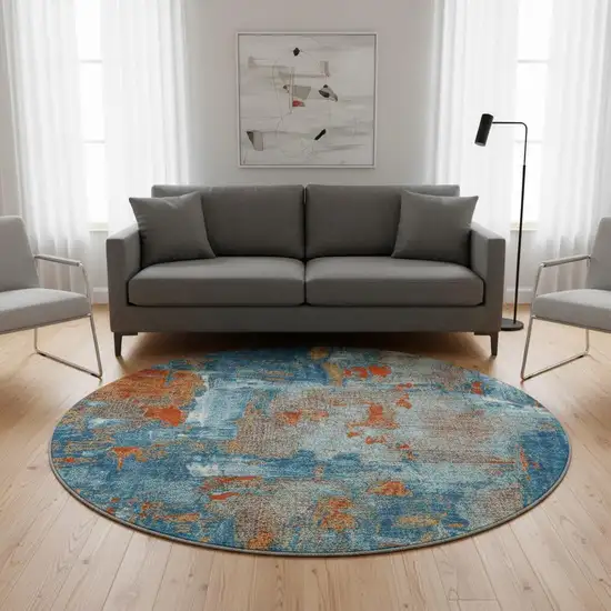 8' Navy Blue Orange And Teal Abstract Washable Round Rug With UV Protection Photo 1