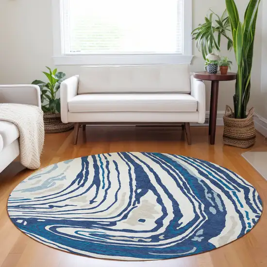 8' Navy Blue Teal Blue And Ivory Round Abstract Washable Indoor Outdoor Area Rug Photo 9