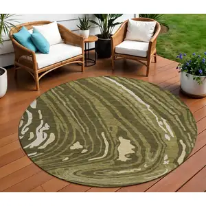 Photo of 8' Olive Green And Beige Round Abstract Washable Indoor Outdoor Area Rug