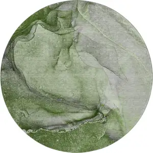 Photo of 8' Olive Green And Ivory Abstract Washable Round Rug With UV Protection