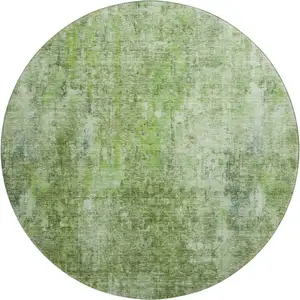 Photo of 8' Olive Green And Ivory Abstract Washable Round Rug With UV Protection