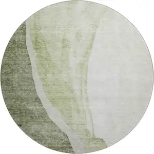 Photo of 8' Olive Green And Ivory Abstract Washable Round Rug With UV Protection