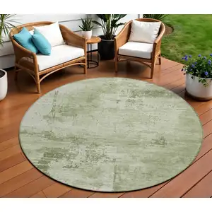Photo of 8' Olive Green And Ivory Round Abstract Washable Indoor Outdoor Area Rug