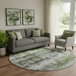 Photo of 8' Olive Green Charcoal And Ivory Abstract Washable Round Rug With UV Protection