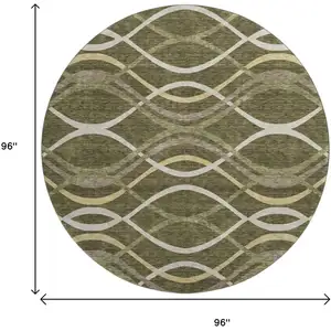 Photo of 8' Olive Green Ivory And Gold Abstract Washable Round Rug With UV Protection