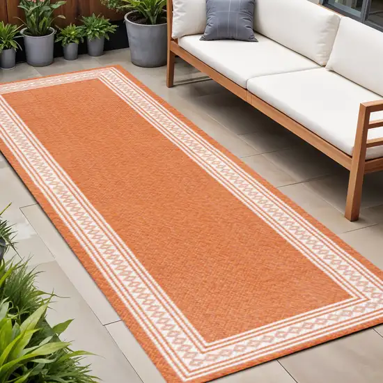 8' Orange And Cream Indoor Outdoor Runner Rug Photo 1