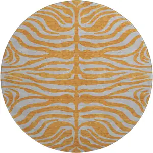 Photo of 8' Orange And Gray Animal Print Washable Round Rug With UV Protection