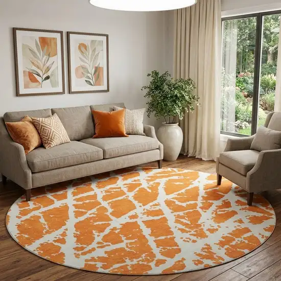 8' Orange And Ivory Abstract Washable Round Rug With UV Protection Photo 1
