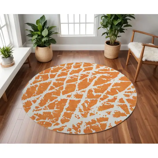 8' Orange And Ivory Abstract Washable Round Rug With UV Protection Photo 2