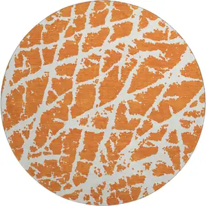 Photo of 8' Orange And Ivory Abstract Washable Round Rug With UV Protection