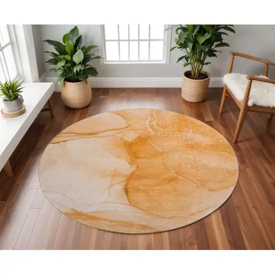 8' Orange And Ivory Abstract Washable Round Rug With UV Protection Photo 2