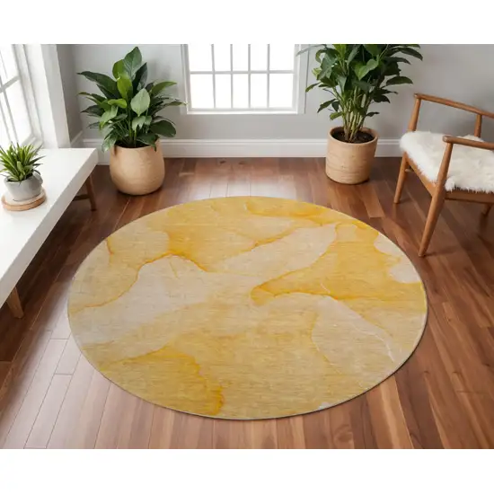 8' Orange And Ivory Abstract Washable Round Rug With UV Protection Photo 2