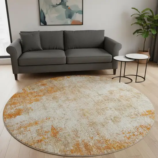 8' Orange And Ivory Abstract Washable Round Rug With UV Protection Photo 2