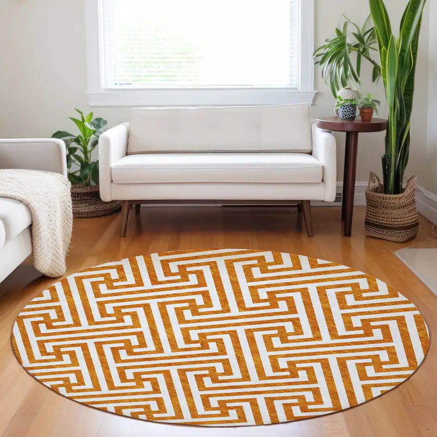 8' Orange And Ivory Geometric Washable Round Rug With UV Protection Photo 5