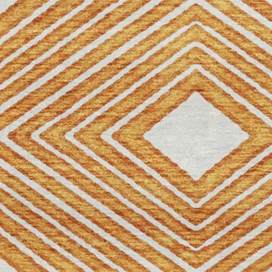 8' Orange And Ivory Geometric Washable Round Rug With UV Protection Photo 4