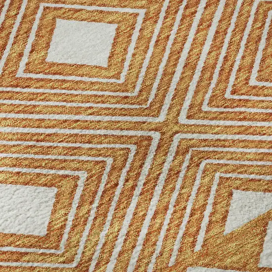 8' Orange And Ivory Geometric Washable Round Rug With UV Protection Photo 9