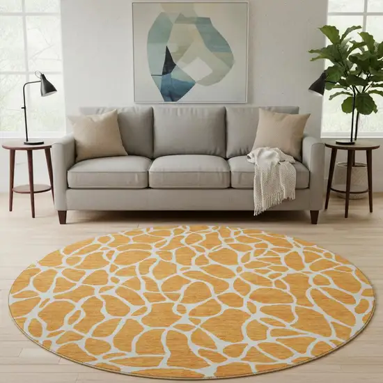 8' Orange And Ivory Geometric Washable Round Rug With UV Protection Photo 2