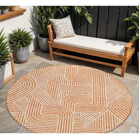8' Orange And Ivory Round Abstract Washable Indoor Outdoor Area Rug Photo 1