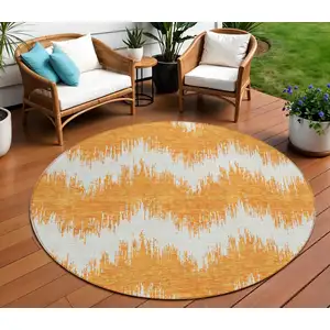Photo of 8' Orange And Ivory Round Chevron Washable Indoor Outdoor Area Rug
