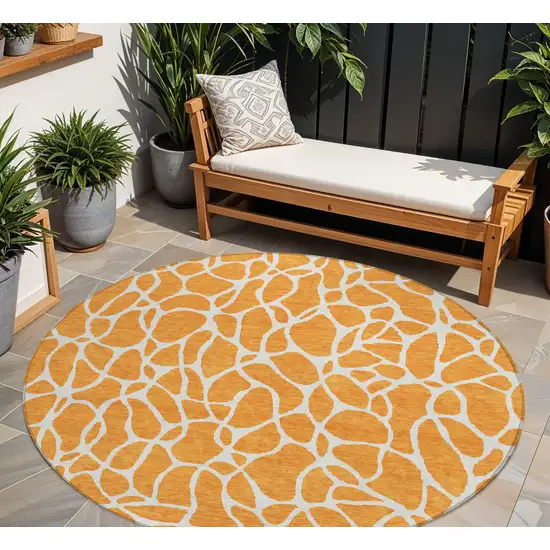 8' Orange And Ivory Round Geometric Washable Indoor Outdoor Area Rug Photo 1