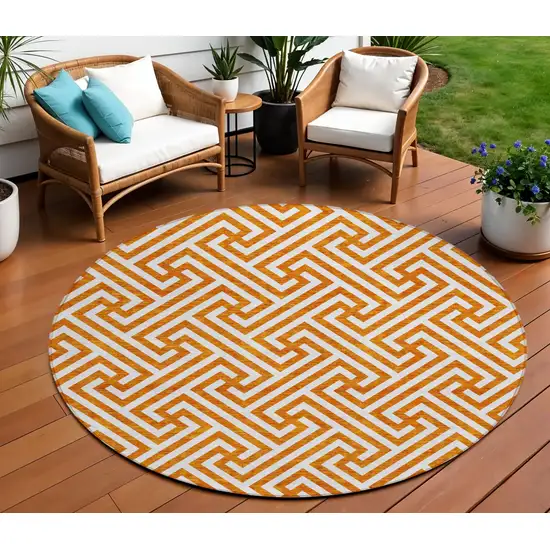 8' Orange And Ivory Round Geometric Washable Indoor Outdoor Area Rug Photo 1