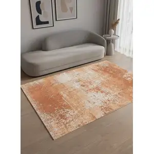 Photo of 8' Orange And White Abstract Washable Round Rug With UV Protection